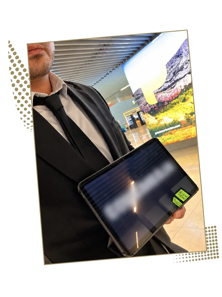 Driver in a suit holding a docking station tablet in a terminal