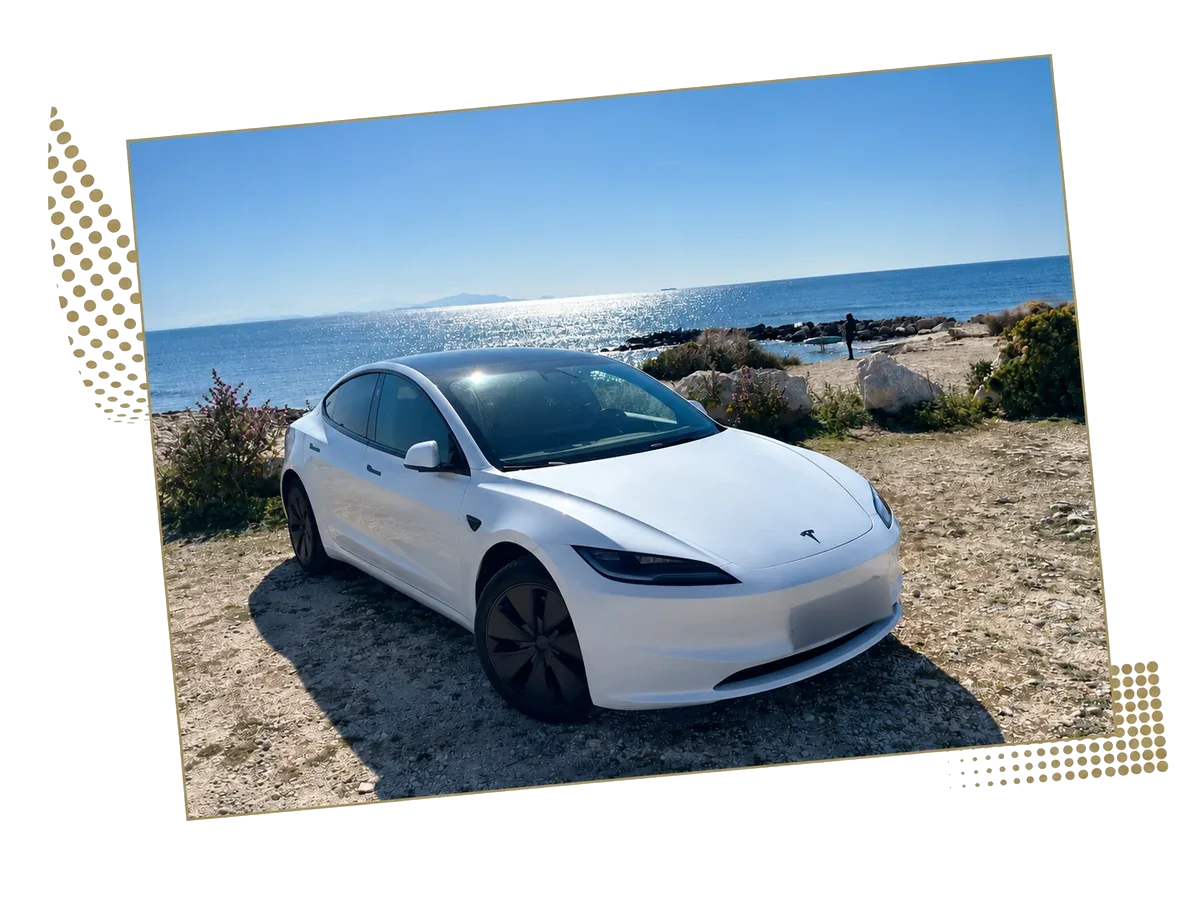 White Tesla Model 3 with the sea in the background