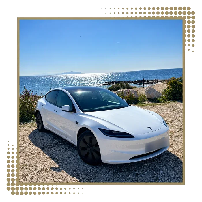 White Tesla Model 3 with the sea in the background