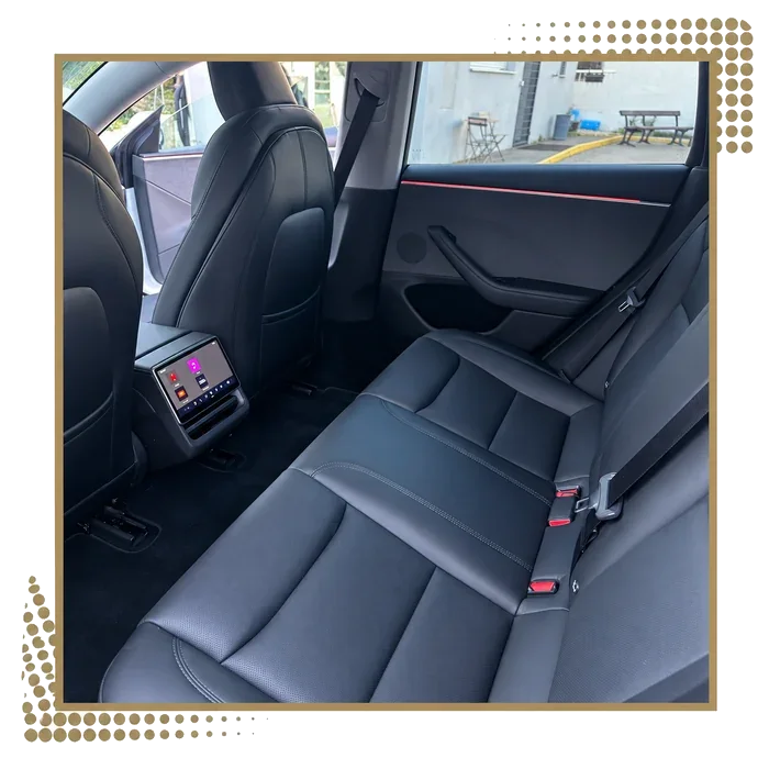 Rear seat and passenger screen of a Tesla Model 3