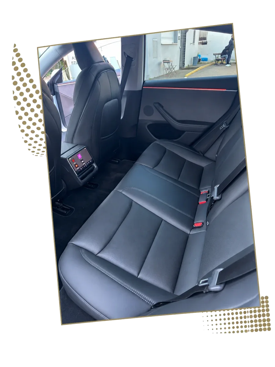 Rear seat and passenger screen of a Tesla Model 3